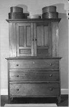 SA1324.12 - Unidentified photo of a cupboard with drawers and oval boxes., Winterthur Shaker Photograph and Post Card Collection 1851 to 1921c